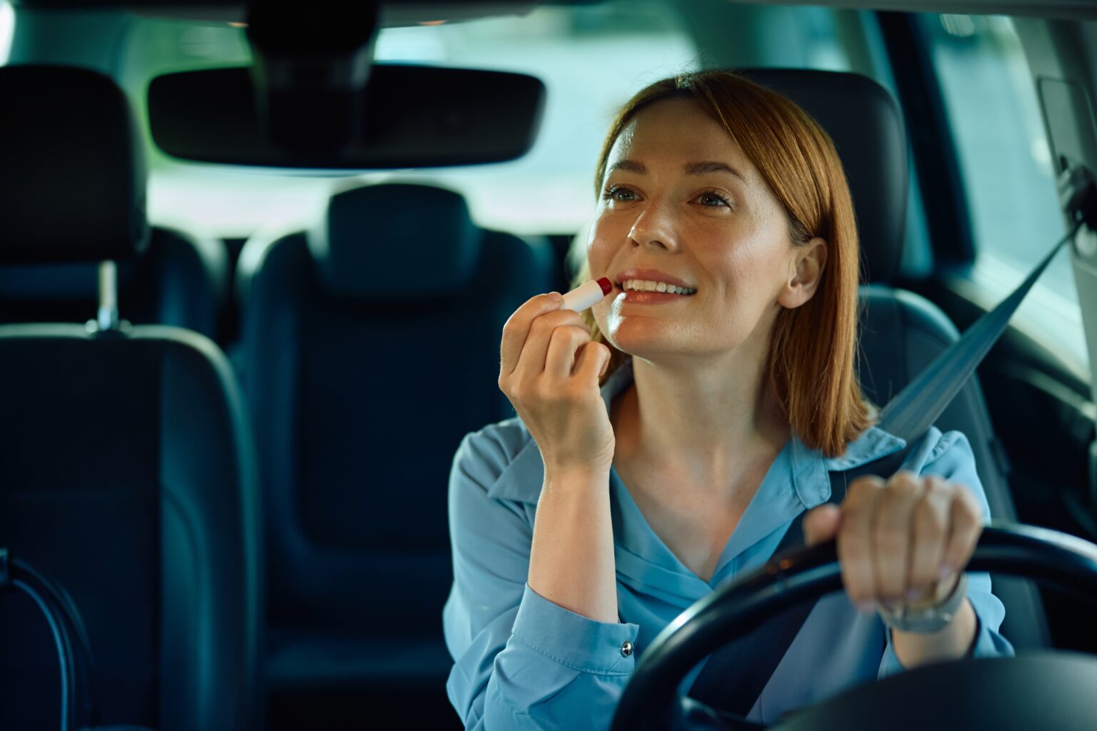 O que ninguém te conta: 10 truques para o batom durar o dia todo, mesmo no calor extremo Mulher aplicando batom dentro do carro e usando truques para fazer o batom durar o dia todo mesmo em dias de muito calor
