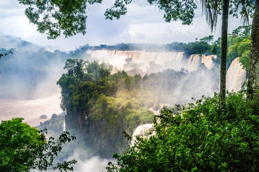 waterfall iguazu national park surrounded by forests covered fog cloudy sky