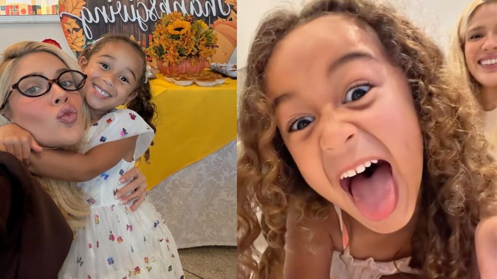 Mulher loira abraça uma menina sorridente em frente a uma mesa decorada de festa infantil; ao lado, a criança de cabelos cacheados aparece em close fazendo careta divertida, com parte do rosto de Karoline Lima visível ao fundo ao lado da filha Cecília.