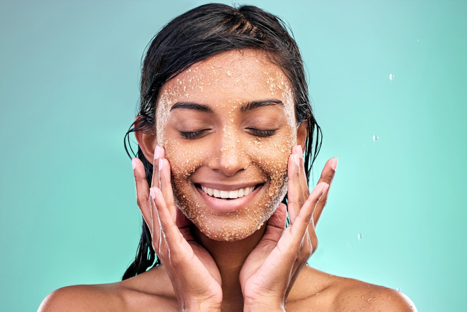 Esfoliar o rosto todo dia faz mal? Veja a frequência ideal para sua pele Mulher aplicando esfoliante no rosto durante rotina de skincare para remover células mortas e melhorar a textura da pele.