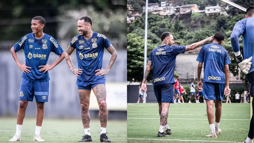 Neymar conversa e sorri ao lado de Robinho Jr, jovem jogador do Santos durante treino em campo de futebol.