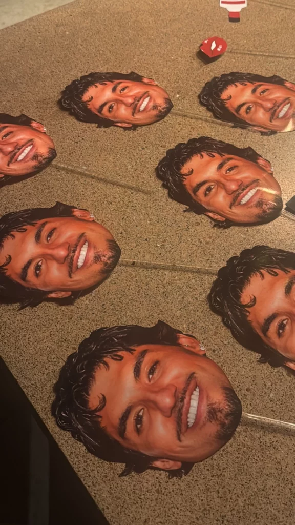 Máscaras com o rosto de Gabriel Medina espalhadas sobre a mesa durante a decoração da despedida de solteira de Isabella Arantes.