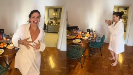 Thais Carla aparece de roupão branco em dois momentos da surpresa de aniversário: sorrindo e dançando ao lado de uma mesa de café da manhã preparada para comemorar seus 35 anos.