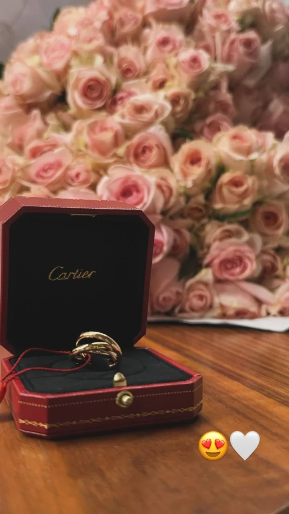 Virginia ganha joia de luxo após término e web suspeita de Zé Felipe 1 Anel dourado da Cartier em uma caixa vermelha, diante de um buquê de rosas cor-de-rosa, compartilhado por Virginia Fonseca no Instagram